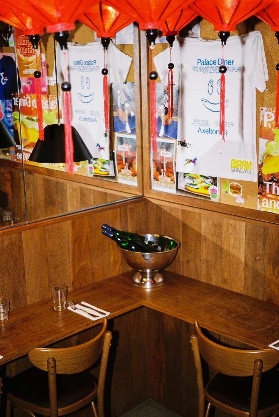 A corner table set by the booth, with wine on ice