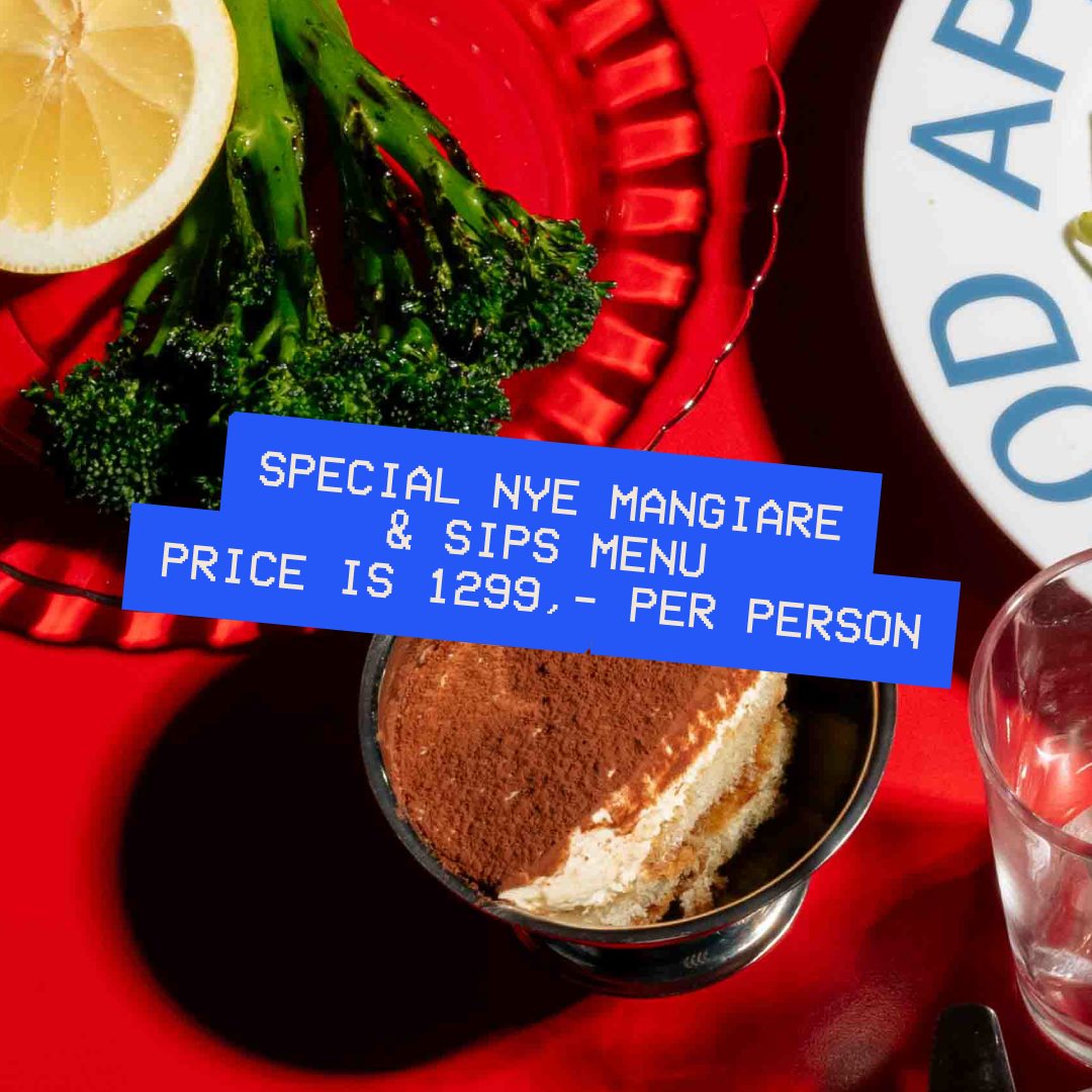 Red table with tiramisu, a drink, broccolini and pasta. Showcasing the sharing menu at Palazzo Diner. 